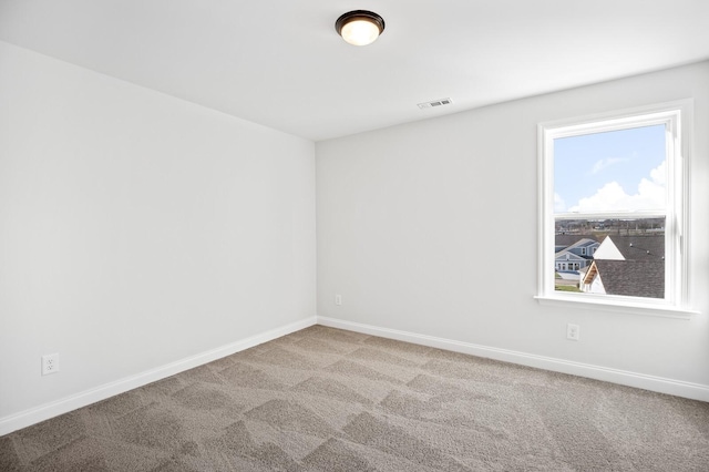 carpeted empty room with baseboards and visible vents