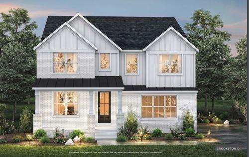 modern farmhouse with metal roof, brick siding, a standing seam roof, and board and batten siding