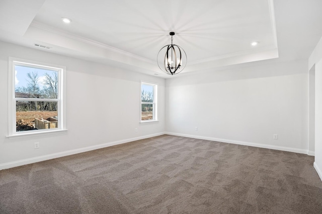 carpeted empty room with a notable chandelier, recessed lighting, a raised ceiling, and baseboards