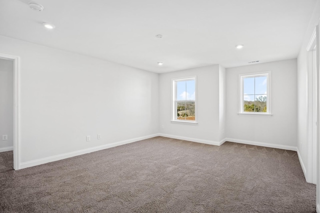 empty room with carpet floors and baseboards