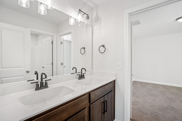 bathroom featuring visible vents, a sink, baseboards, and double vanity