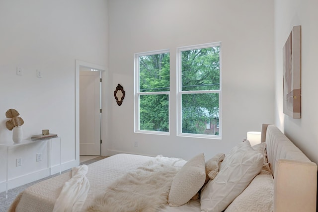 bedroom featuring multiple windows and baseboards