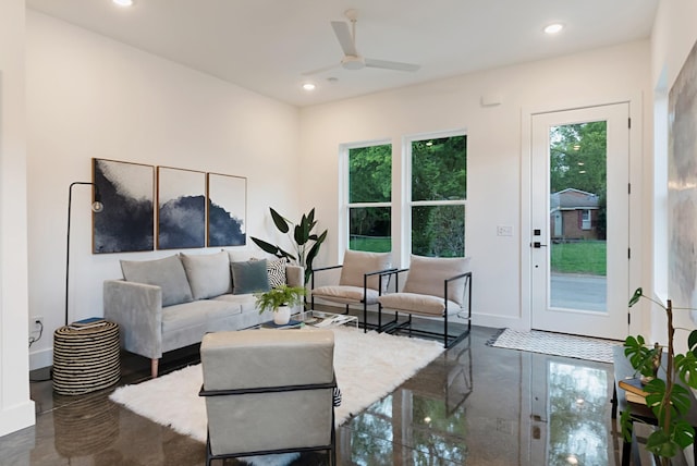 living room featuring baseboards, a ceiling fan, and recessed lighting