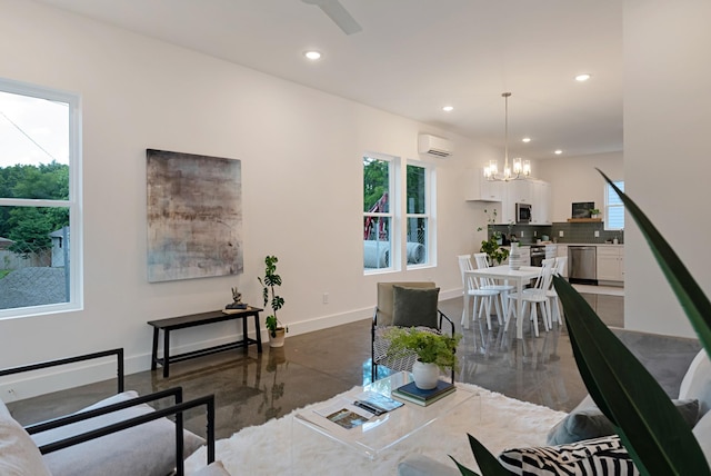 living area with an inviting chandelier, recessed lighting, baseboards, and a wall mounted AC