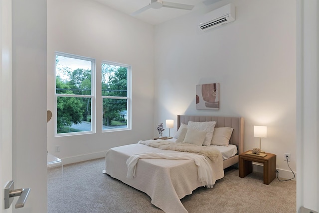 bedroom featuring a ceiling fan, baseboards, a wall mounted air conditioner, and carpet flooring