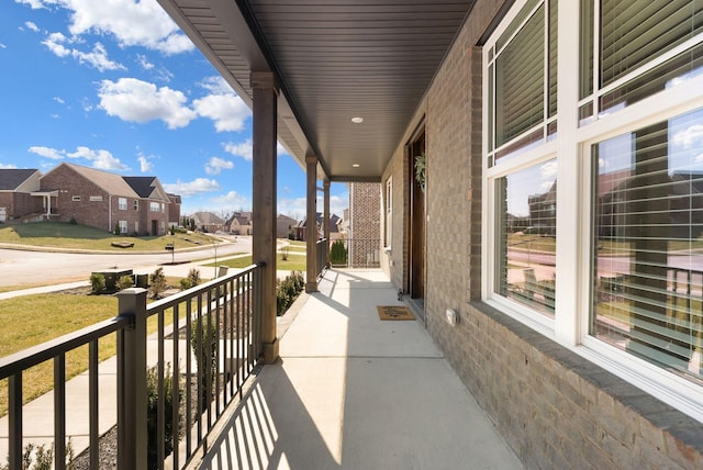 view of patio / terrace featuring a balcony and a residential view