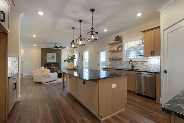 kitchen featuring dishwasher, ornamental molding, open floor plan, and a fireplace