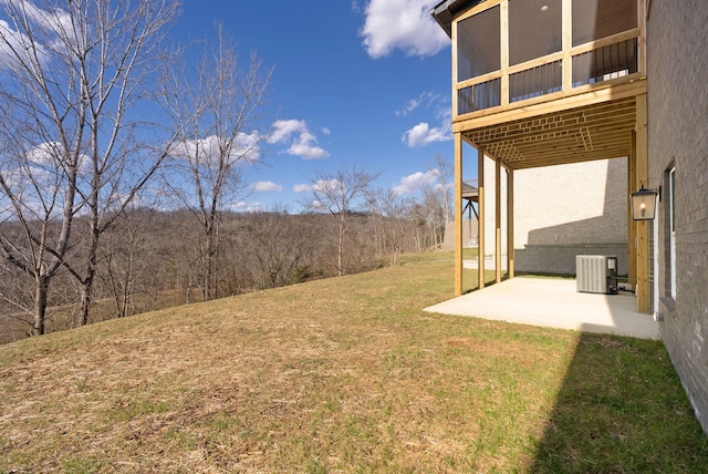 view of yard featuring a patio and central air condition unit