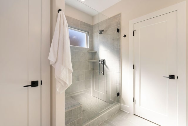 full bathroom featuring a shower stall and tile patterned floors