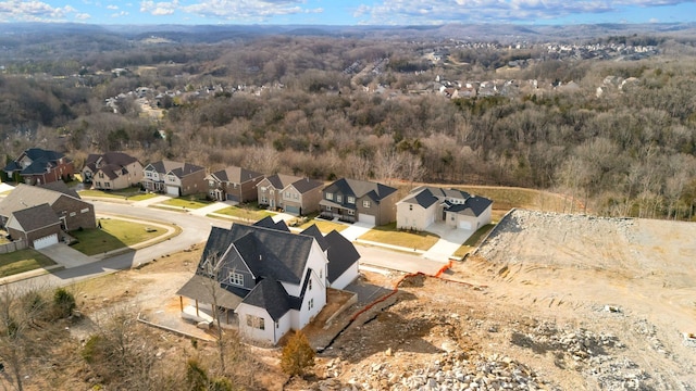 drone / aerial view with a forest view and a residential view