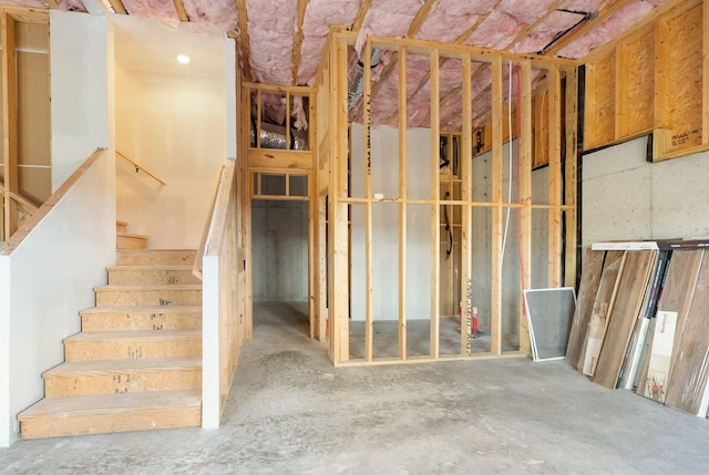 unfinished basement featuring stairway