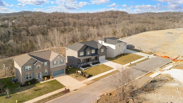 birds eye view of property with a wooded view