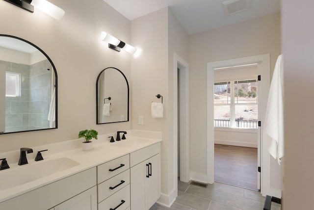 full bath with tile patterned floors, visible vents, a sink, and double vanity