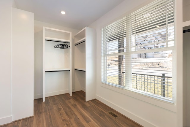 spacious closet with dark wood finished floors and visible vents