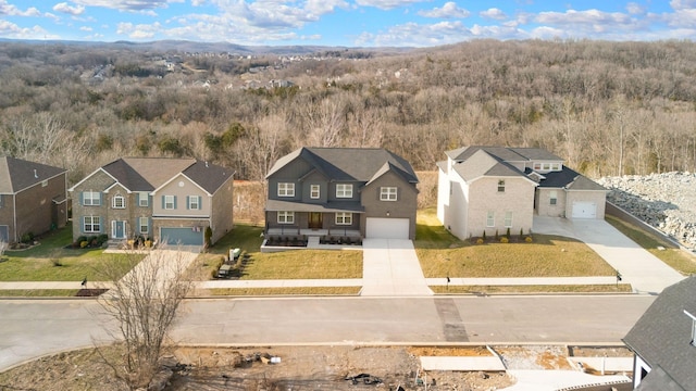 birds eye view of property featuring a residential view and a wooded view