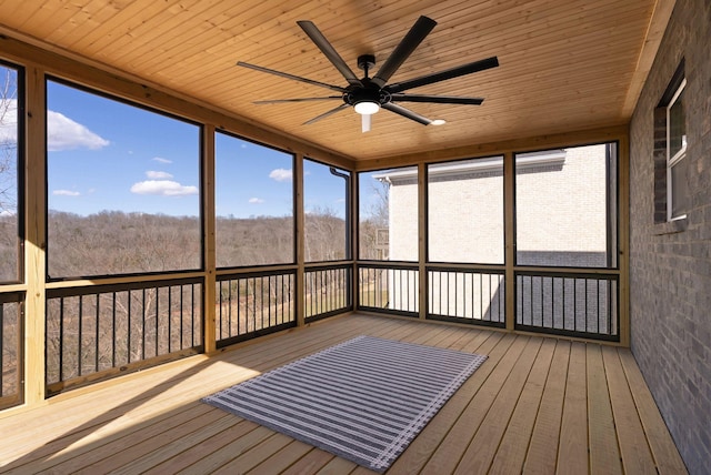 unfurnished sunroom featuring a ceiling fan and wood ceiling