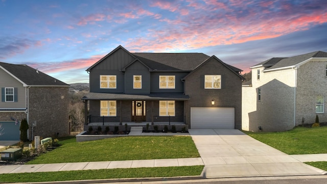 view of front of home with board and batten siding, concrete driveway, a porch, and a front lawn