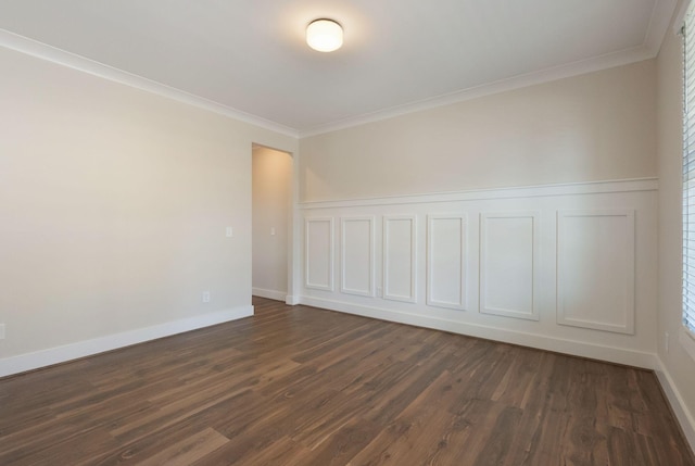 unfurnished room featuring dark wood-style flooring, crown molding, and baseboards