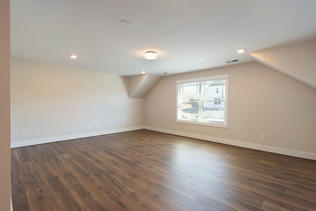 bonus room featuring recessed lighting, dark wood-style flooring, visible vents, baseboards, and vaulted ceiling