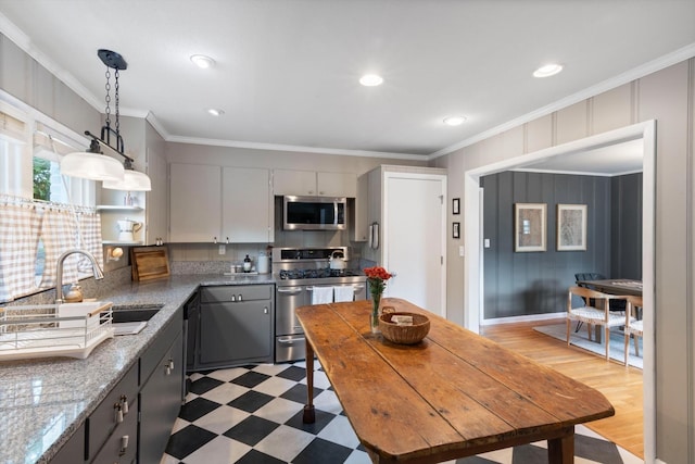 kitchen with a sink, light floors, stainless steel appliances, and crown molding