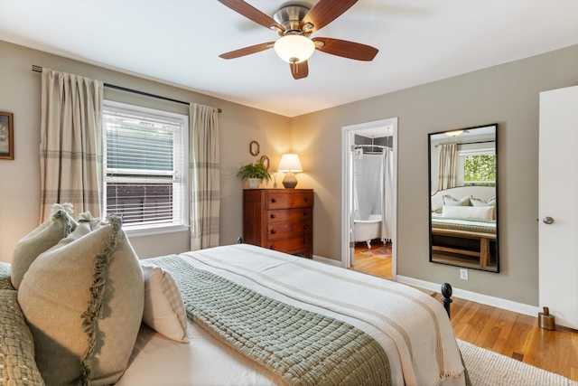 bedroom featuring a ceiling fan, baseboards, and wood finished floors