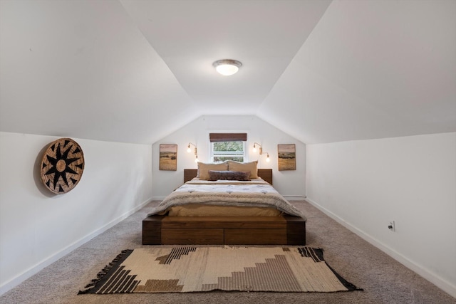 bedroom with carpet, baseboards, and vaulted ceiling