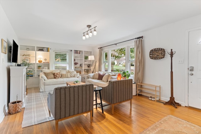 living room featuring baseboards and light wood finished floors