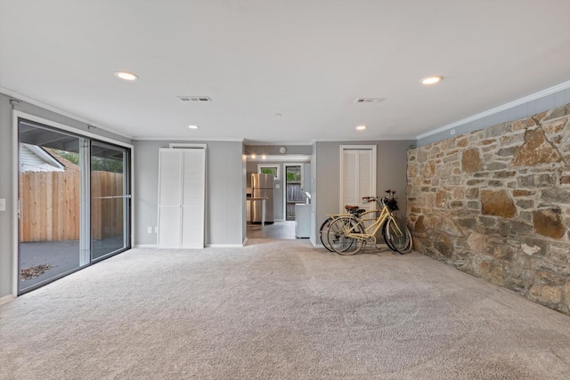 empty room with carpet floors, visible vents, ornamental molding, and recessed lighting