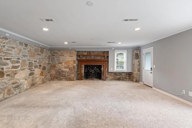 unfurnished living room featuring a fireplace, carpet flooring, visible vents, and crown molding