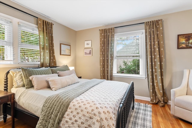 bedroom featuring baseboards and wood finished floors