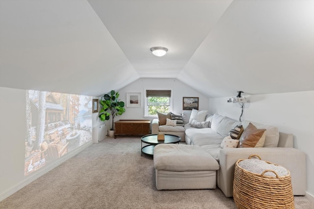 living area with vaulted ceiling and light colored carpet