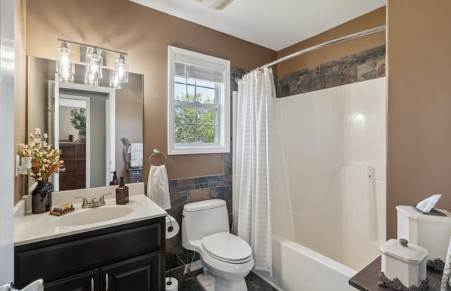bathroom featuring toilet, tile walls, shower / tub combo with curtain, and vanity