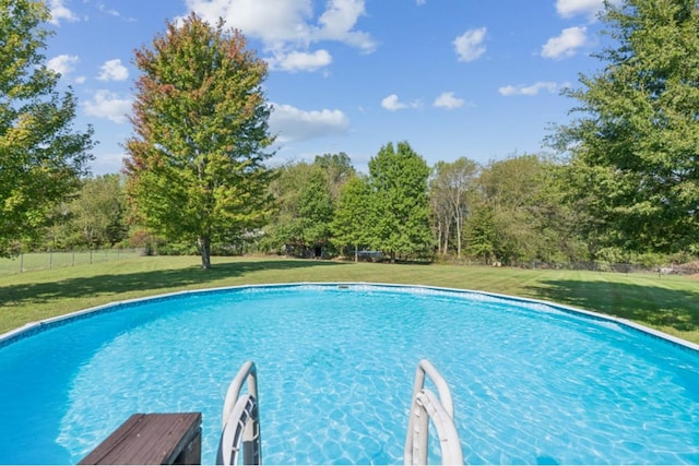 pool featuring a yard and fence