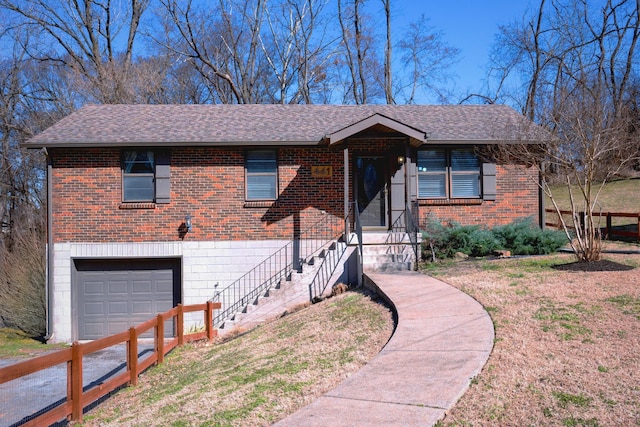 view of front of home featuring a shingled roof, a front yard, brick siding, and an attached garage