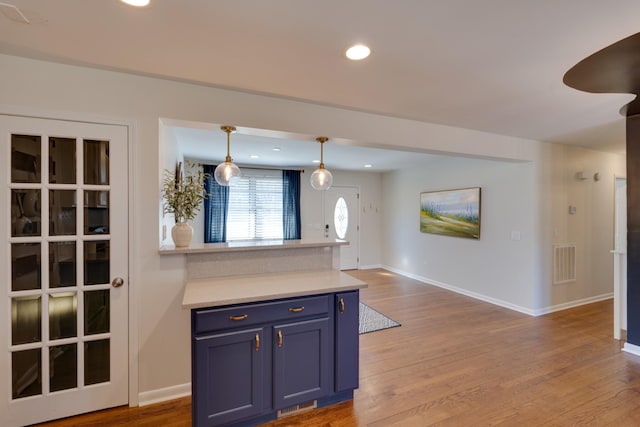 kitchen with visible vents, wood finished floors, blue cabinets, light countertops, and recessed lighting