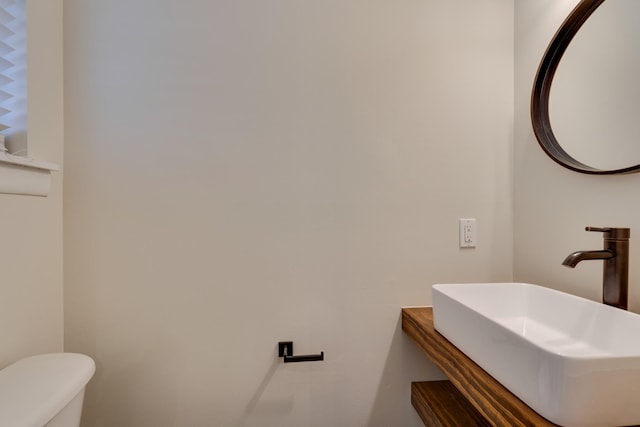 bathroom with toilet and a sink