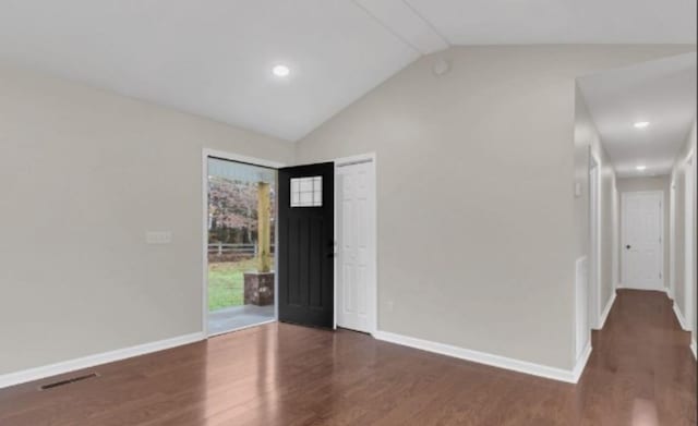 foyer with vaulted ceiling, baseboards, and wood finished floors