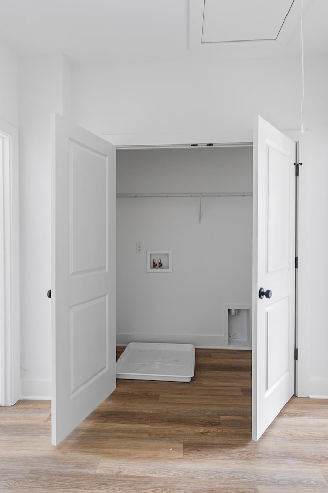 laundry room featuring washer hookup, laundry area, baseboards, and light wood finished floors