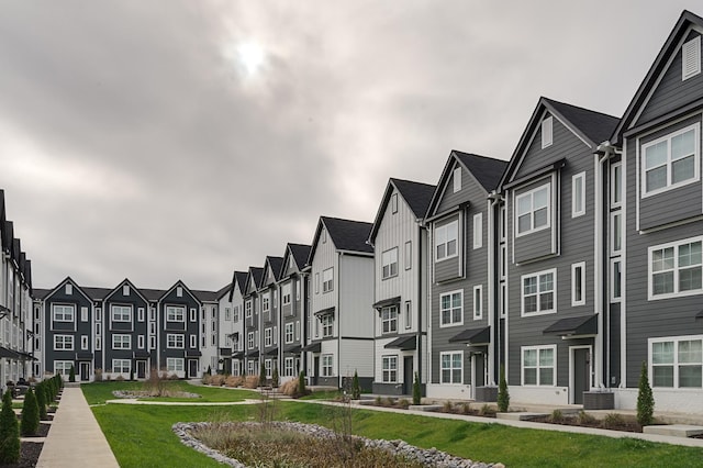 view of building exterior featuring cooling unit and a residential view