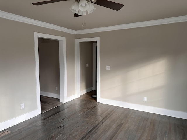 empty room with ceiling fan, dark wood finished floors, and ornamental molding