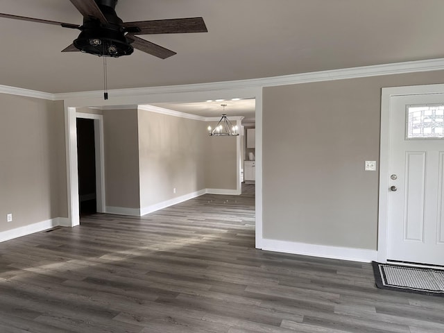unfurnished living room featuring dark wood finished floors, ceiling fan with notable chandelier, baseboards, and ornamental molding