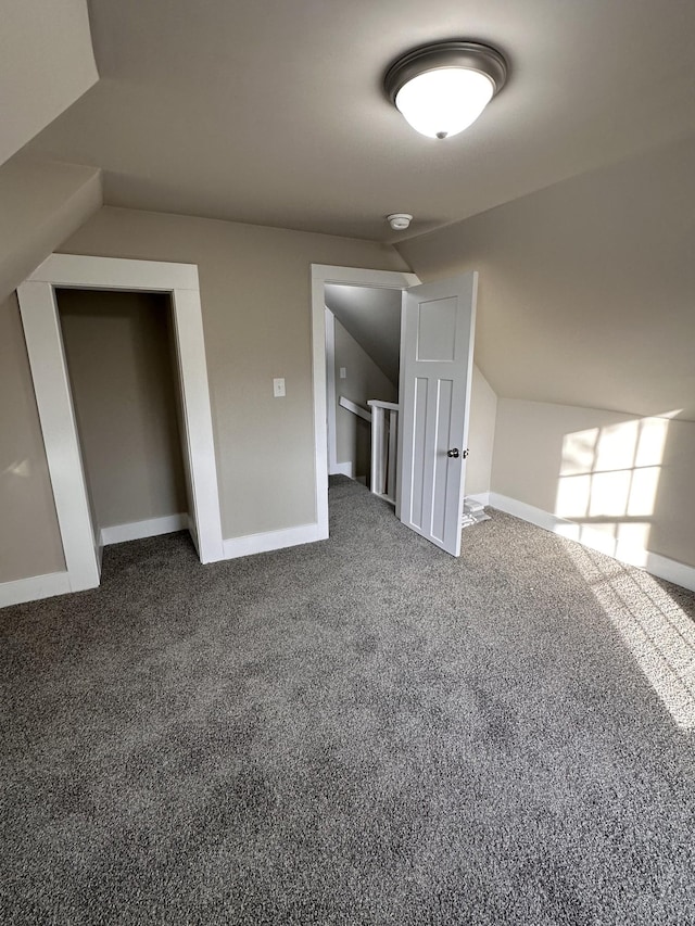 bonus room featuring baseboards, carpet, and vaulted ceiling