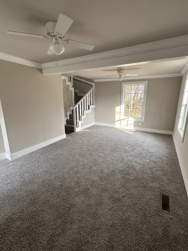 carpeted empty room with stairs, visible vents, a ceiling fan, and crown molding