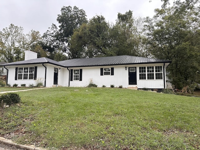 single story home with a chimney and a front yard