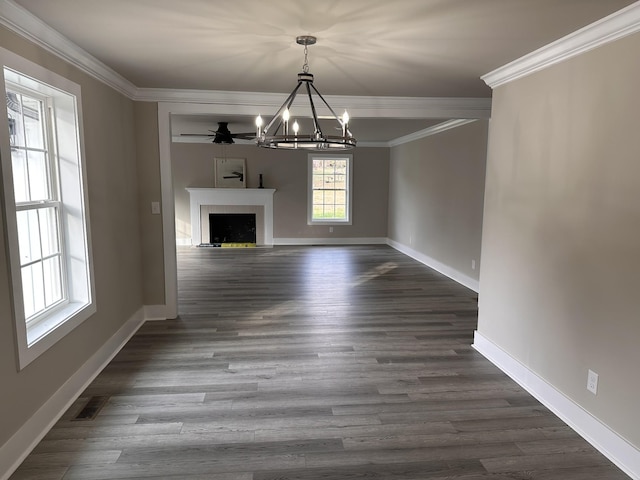 unfurnished living room featuring visible vents, dark wood-type flooring, baseboards, and ornamental molding