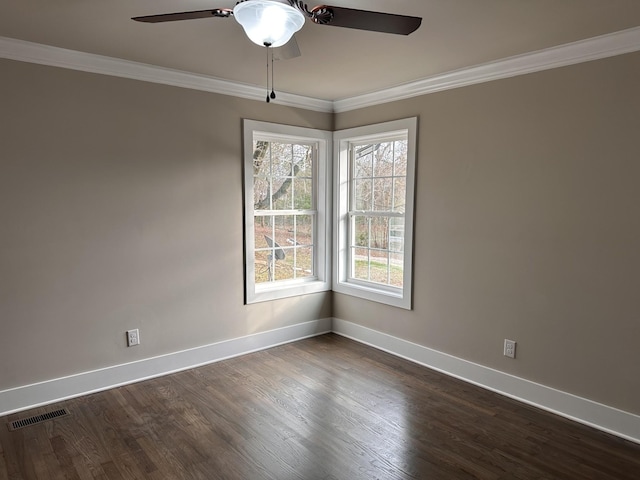 unfurnished room with crown molding, a ceiling fan, dark wood-style flooring, and baseboards