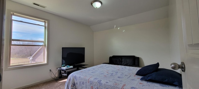 bedroom with lofted ceiling, carpet, visible vents, and baseboards