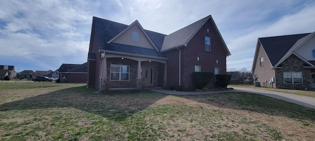 traditional home featuring central air condition unit, board and batten siding, and a front lawn