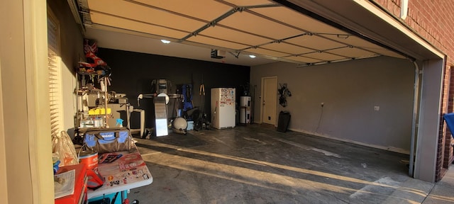 garage with gas water heater and a garage door opener