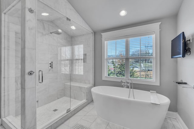 bathroom with marble finish floor, a stall shower, a soaking tub, and baseboards